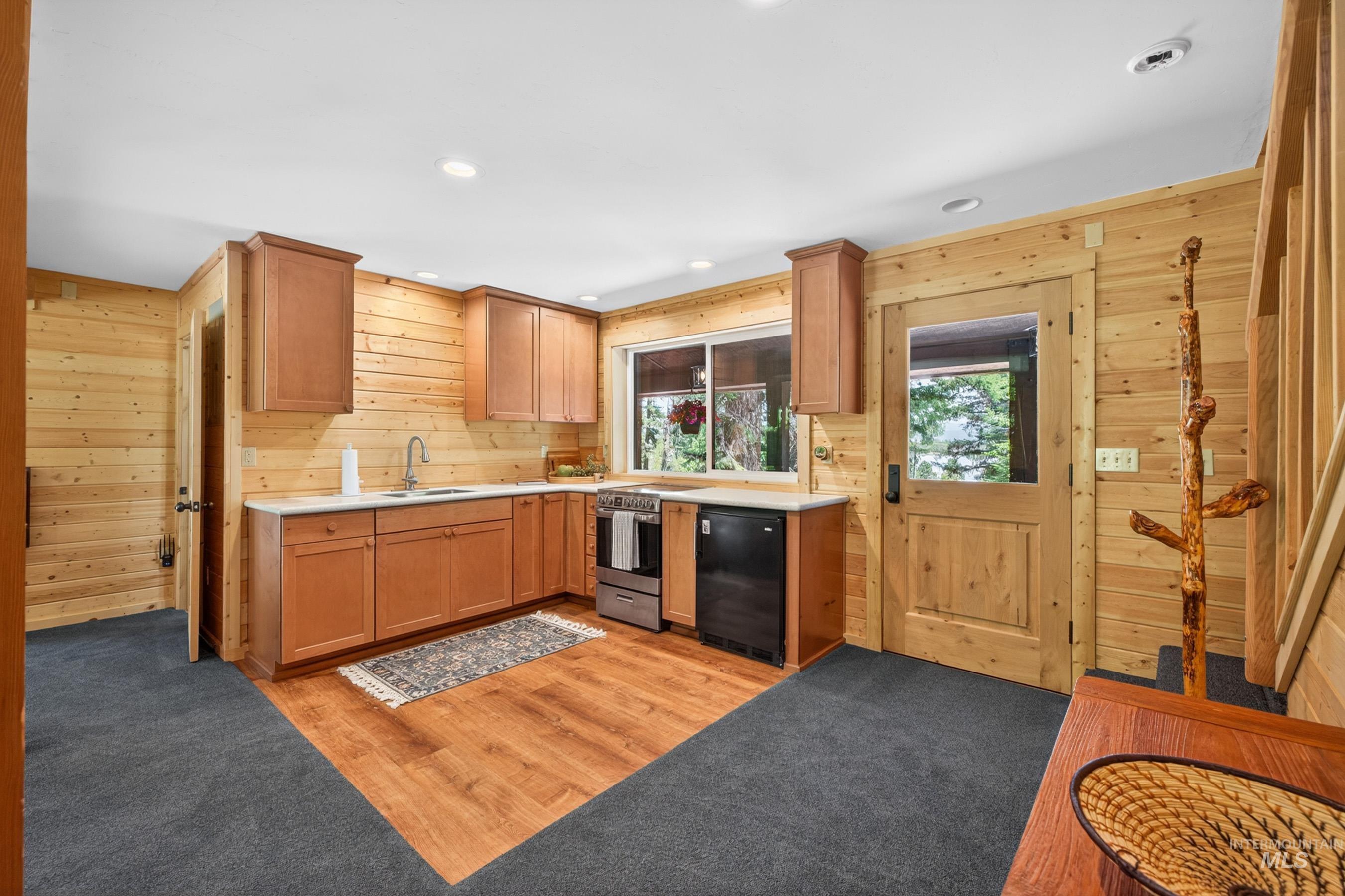 2339 West Mountain Road Donnelly, ID 83615 - Photo 36 of 37 Kitchen area featuring wood-finish cabinetry, a stainless steel range, and a compact refrigerator