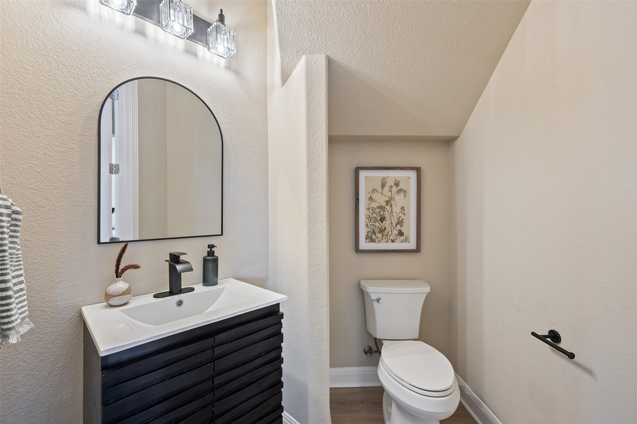 2702 Lakehurst Road Spicewood, TX 78669 - Photo 32 of 40 a bathroom with a toilet sink and mirror