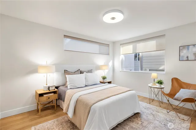 a bedroom with a bed and wooden floor