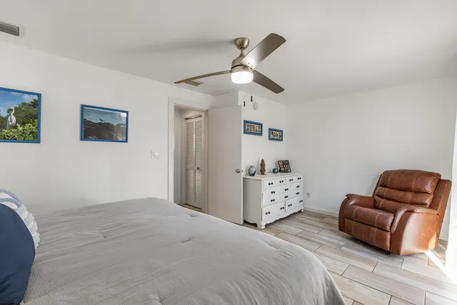 a spacious bedroom with a bed and furniture