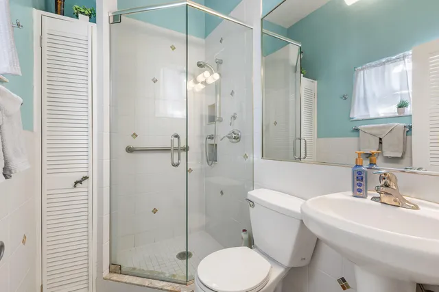 a bathroom with a sink toilet and shower