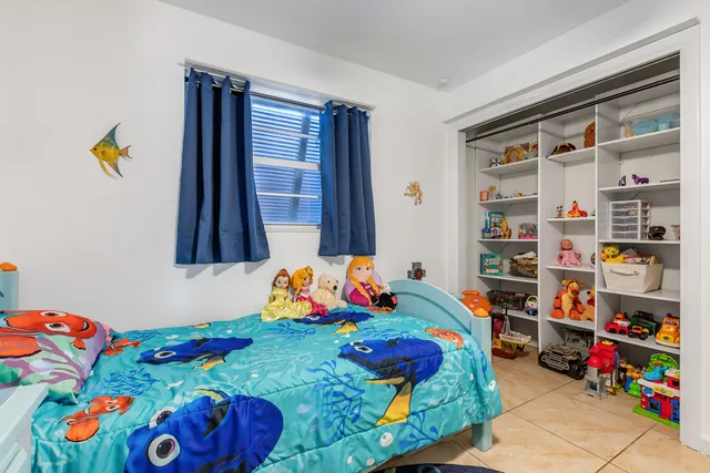 a bedroom with toys and a book shelf