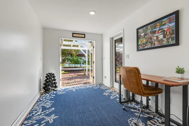 a view of a workspace with furniture and a window