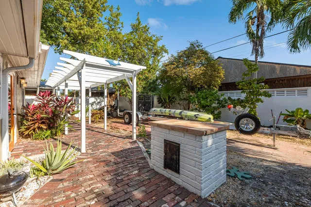 a view of a patio with table and chairs potted plants