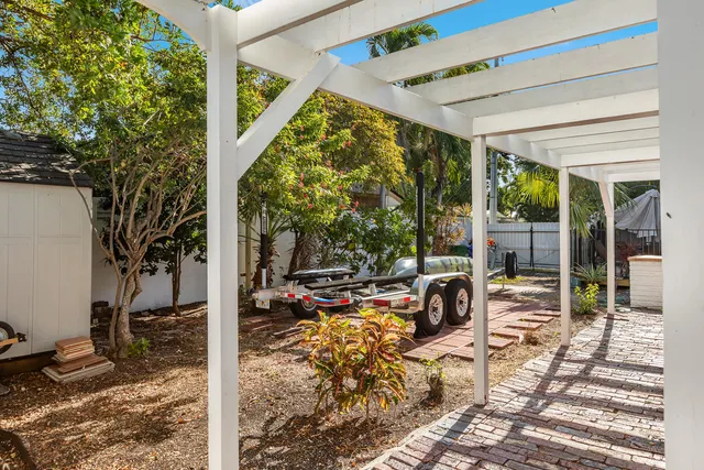 a view of a porch with furniture and garden