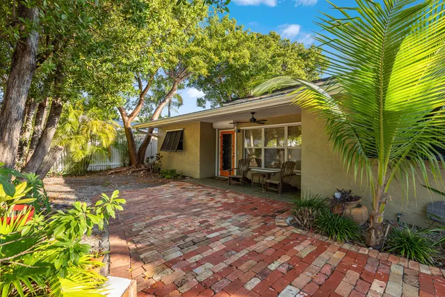 a backyard of a house with table and chairs