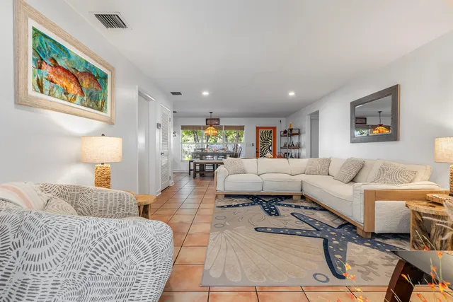 a living room with furniture and painting on the wall