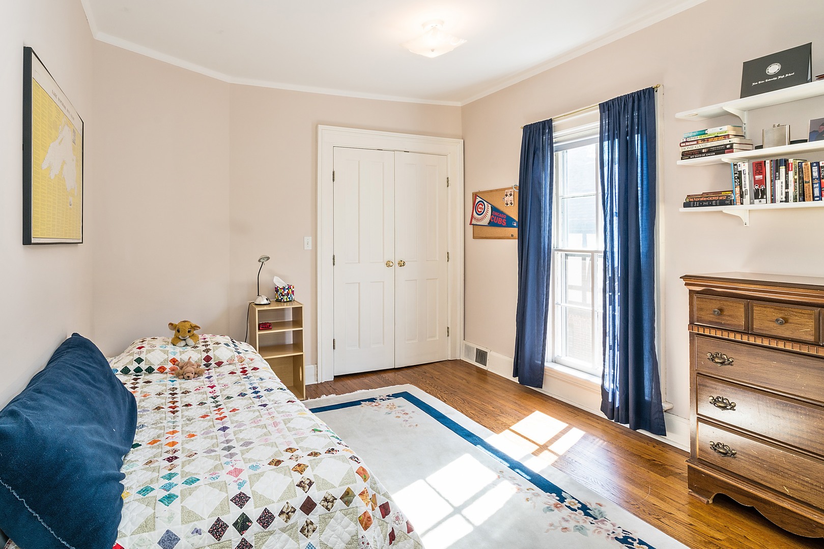 548 Willow Road Winnetka, IL 60093 - Photo 12 of 26 a bedroom with a bed and a book shelf