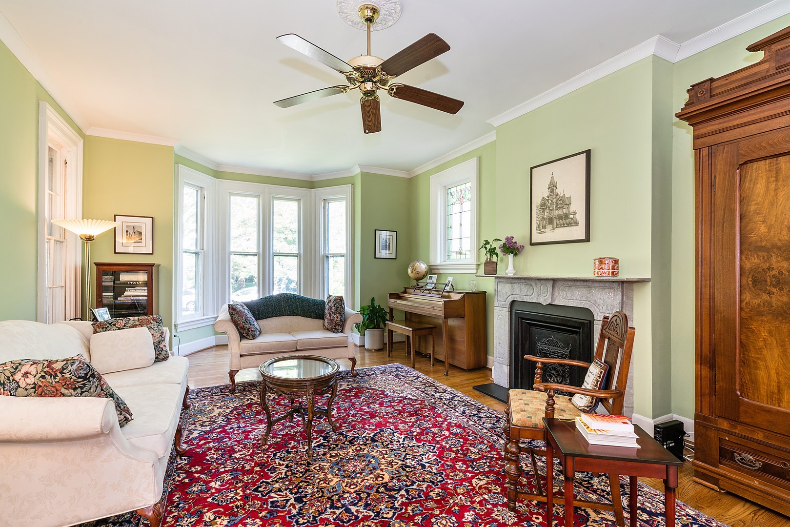 548 Willow Road Winnetka, IL 60093 - Photo 3 of 26 a living room with furniture fireplace and a large window