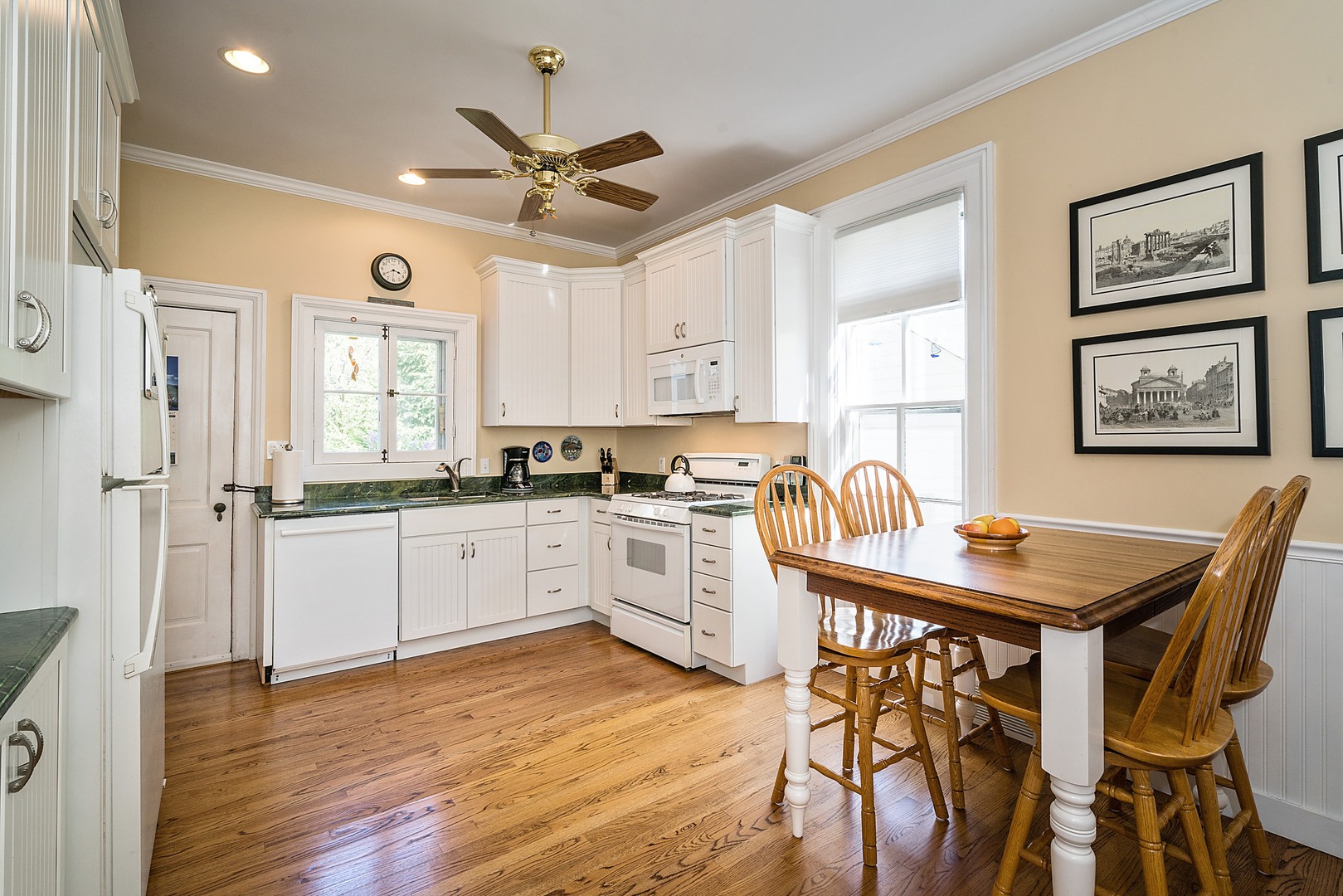 548 Willow Road Winnetka, IL 60093 - Photo 5 of 26 a kitchen with a table chairs refrigerator and cabinets
