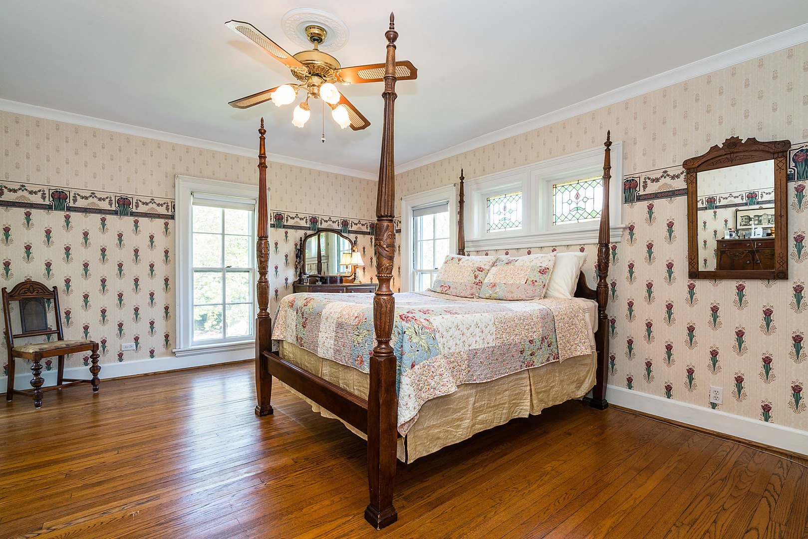 548 Willow Road Winnetka, IL 60093 - Photo 9 of 26 a bedroom with a bed and wooden floor
