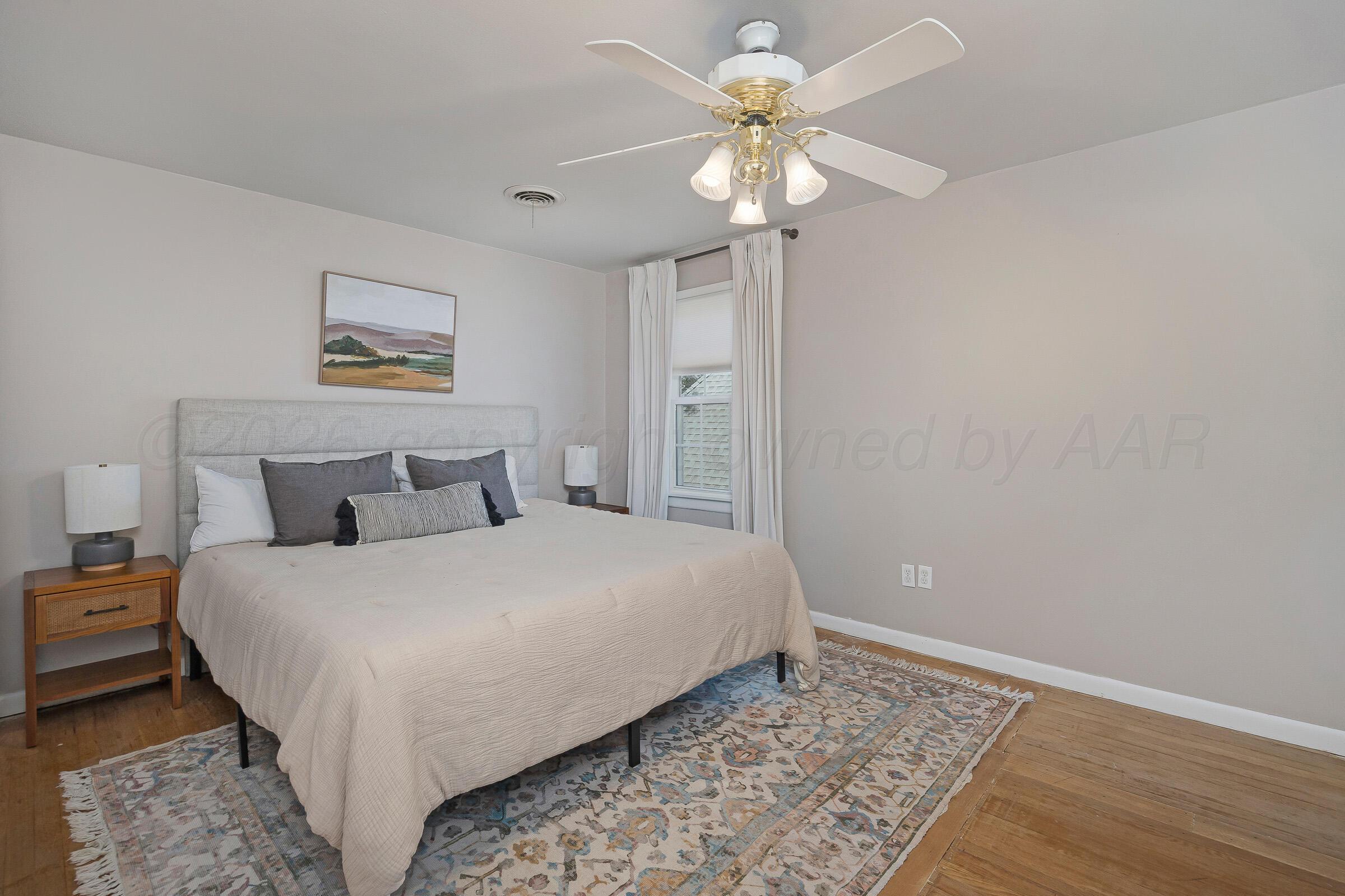 2102 South Hayden Street Amarillo, TX 79109 - Photo 30 of 44 a bedroom with a bed and a chandelier