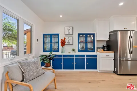 a kitchen with stainless steel appliances a refrigerator a sink a stove a microwave and cabinets