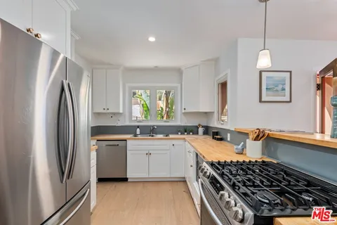 a kitchen with a stove a sink and a refrigerator