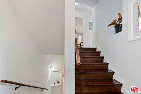 a spacious bedroom with a large bed and a large window