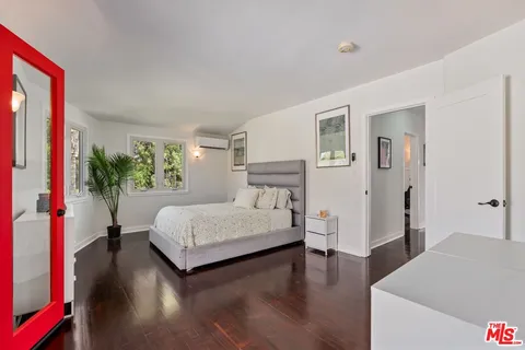 a bedroom with furniture and a window