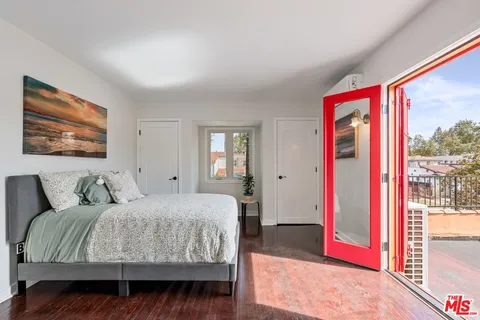 a porch with a bench next to a yard