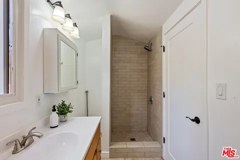 a bathroom with a tub sink and mirror