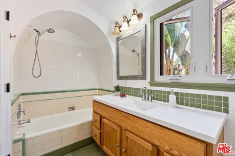 a view of street along with house and trees