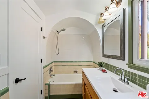 a backyard of a house with potted plants and large trees
