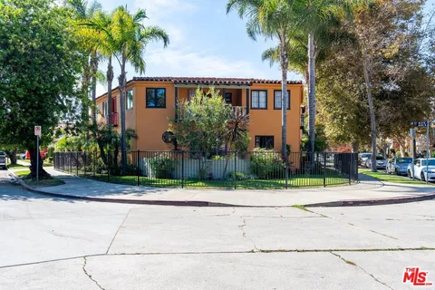 a view of a patio with table and chairs under an umbrella