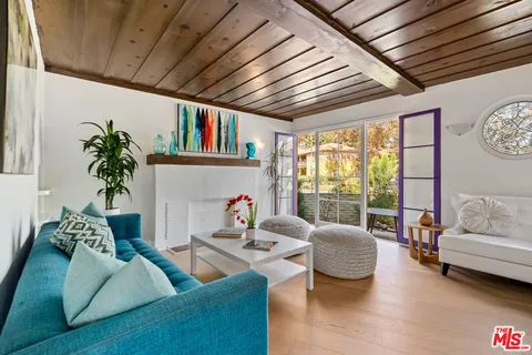 a living room with furniture or couch and a large window