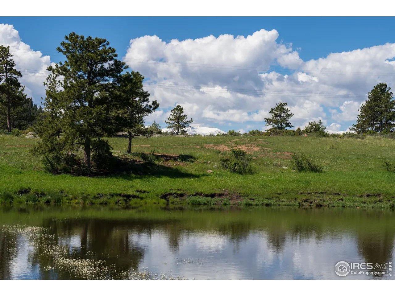 Legacy Rock Road Livermore, CO 80536 - Photo 4 of 11 a view of a lake with houses in the back