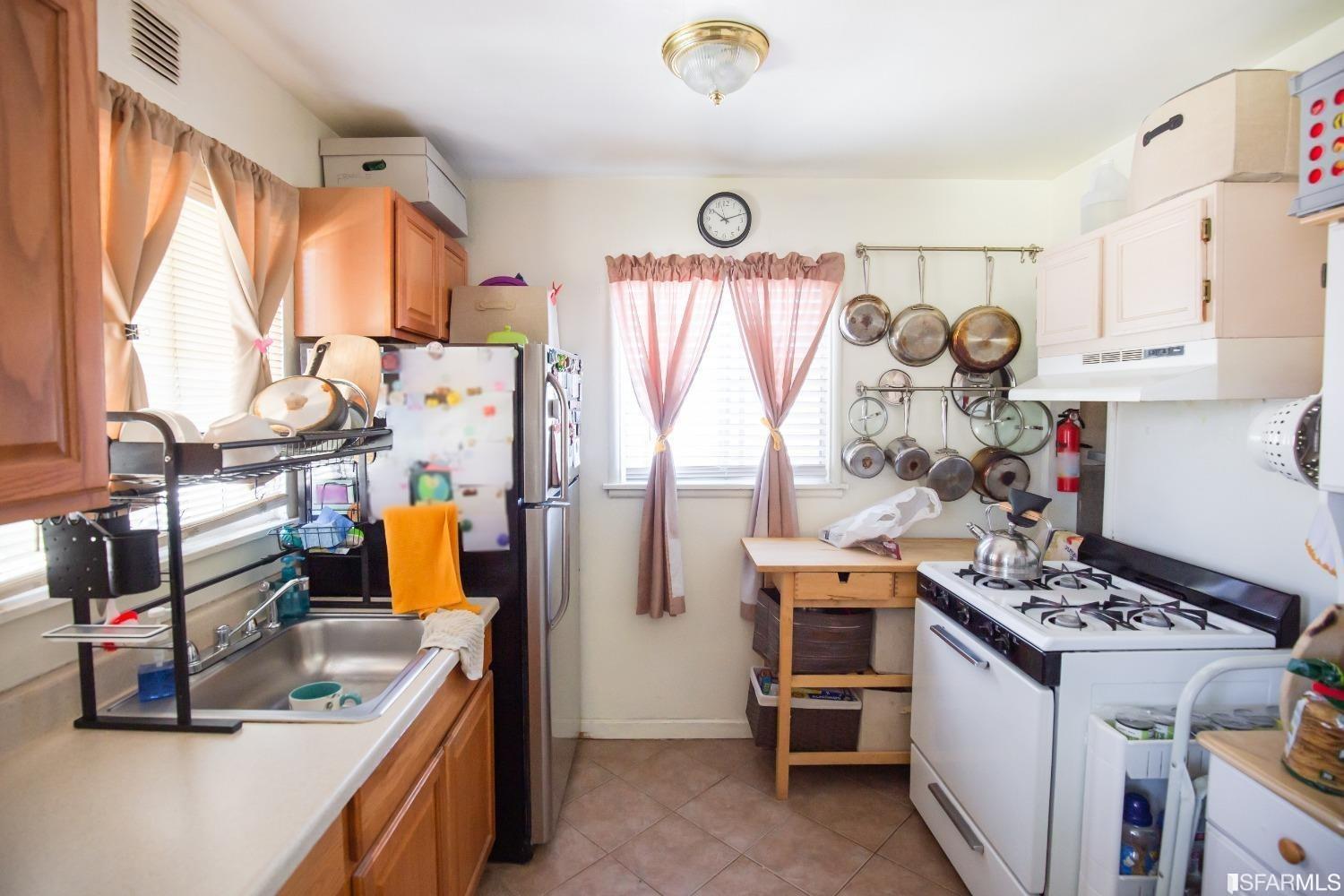 1616 Prince Street Berkeley, CA 94703 - Photo 11 of 20 a kitchen with stainless steel appliances granite countertop a stove and a refrigerator