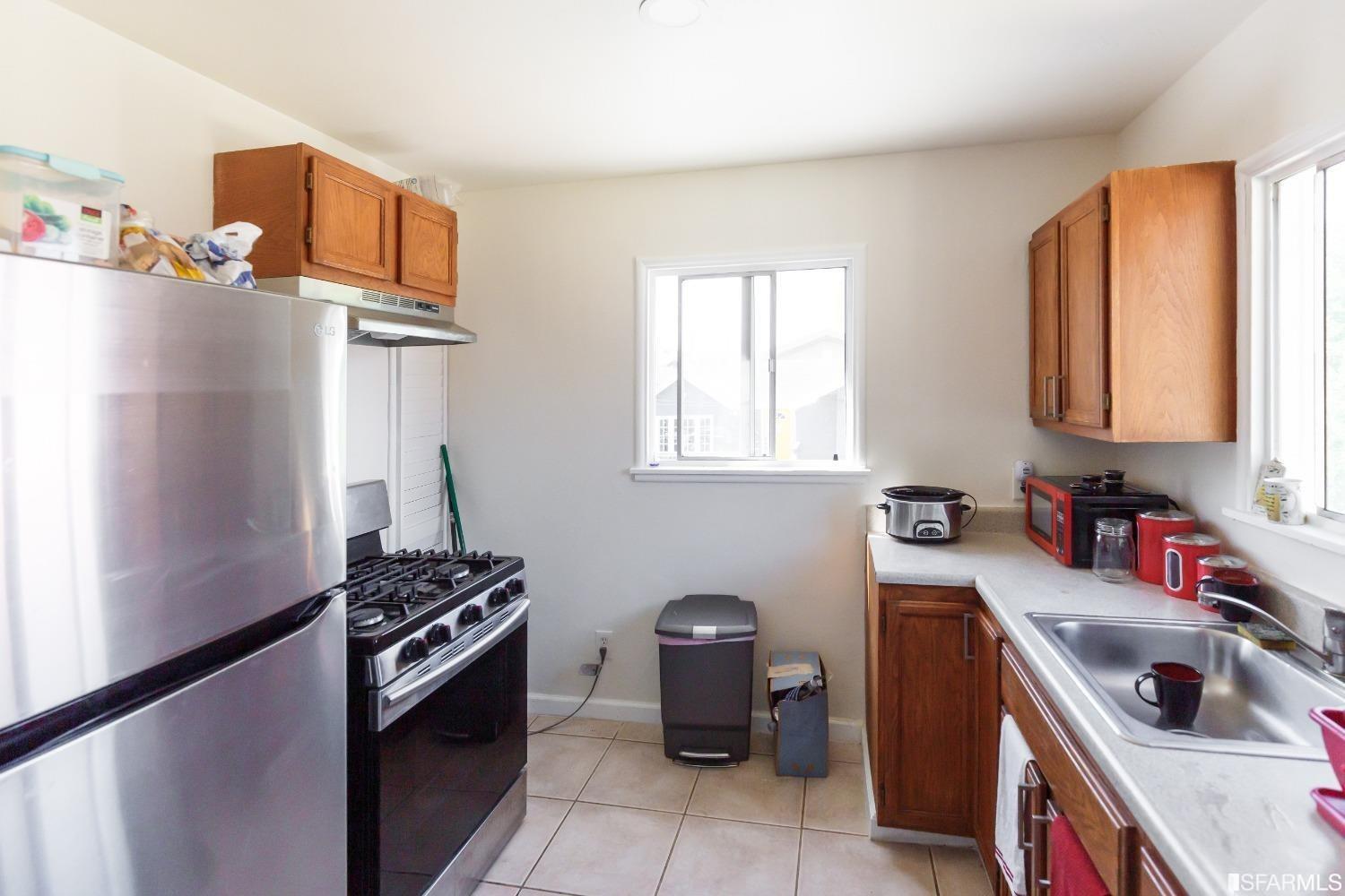 1616 Prince Street Berkeley, CA 94703 - Photo 12 of 20 a kitchen with stainless steel appliances a stove a sink and a refrigerator