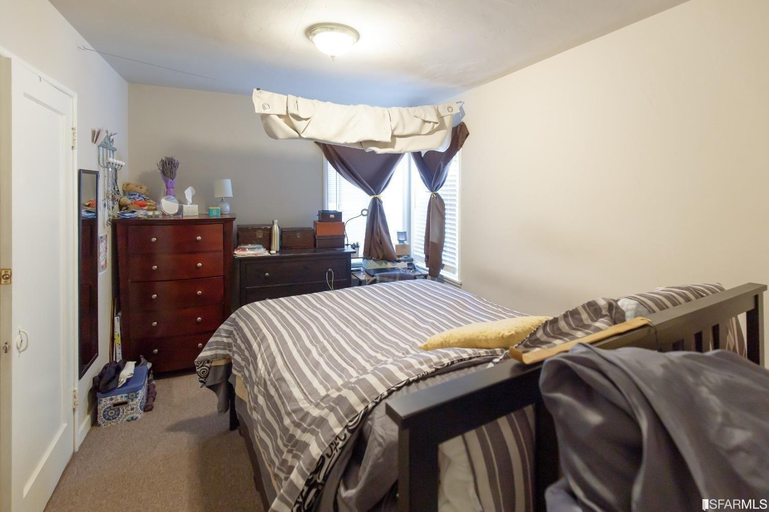 1616 Prince Street Berkeley, CA 94703 - Photo 8 of 20 a bedroom with a bed and a mirror