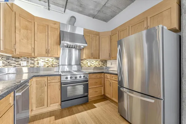 a stove top oven sitting inside of a kitchen