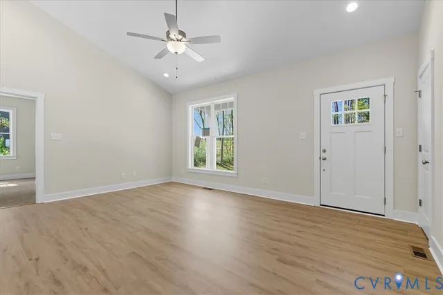 a kitchen with kitchen island a sink dishwasher a stove and a refrigerator with wooden floor