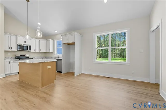 a view of kitchen with sink and microwave