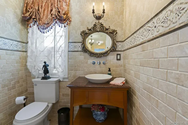 a bathroom with a sink a toilet and a mirror