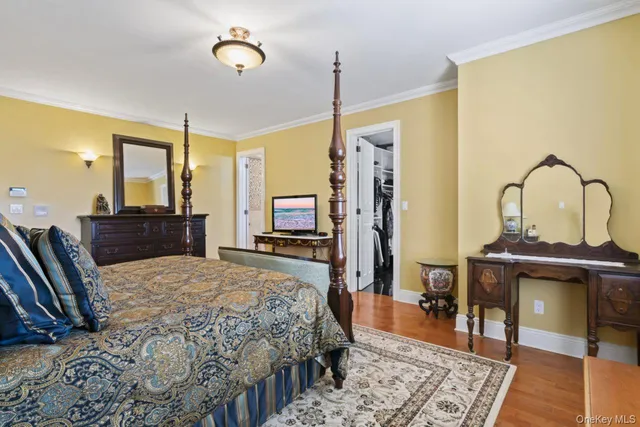 a bedroom with a bed a dresser and chair