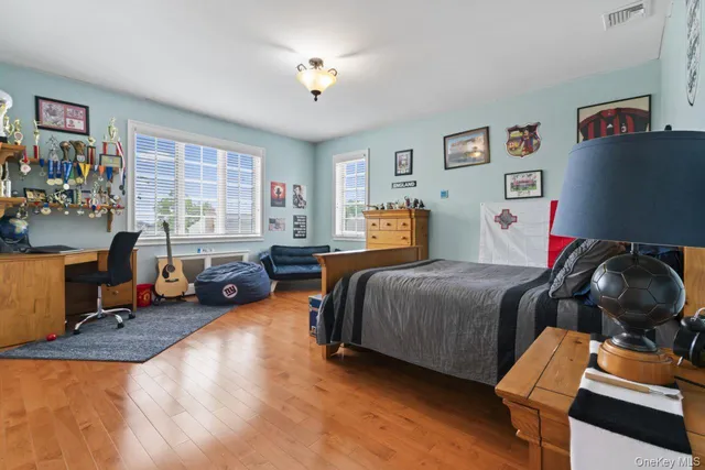 a bedroom with bed and a large window