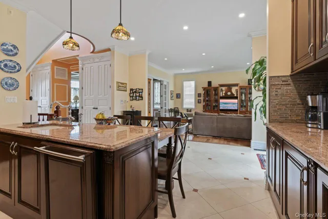 a kitchen with a table chairs sink and cabinets