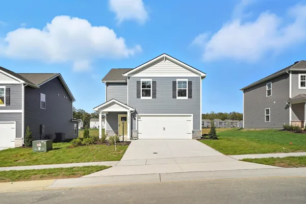 a front view of a house with a yard