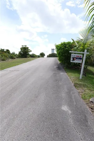 a view of a street with a yard
