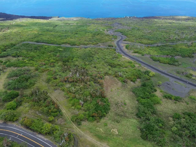 a view of a field with an ocean view