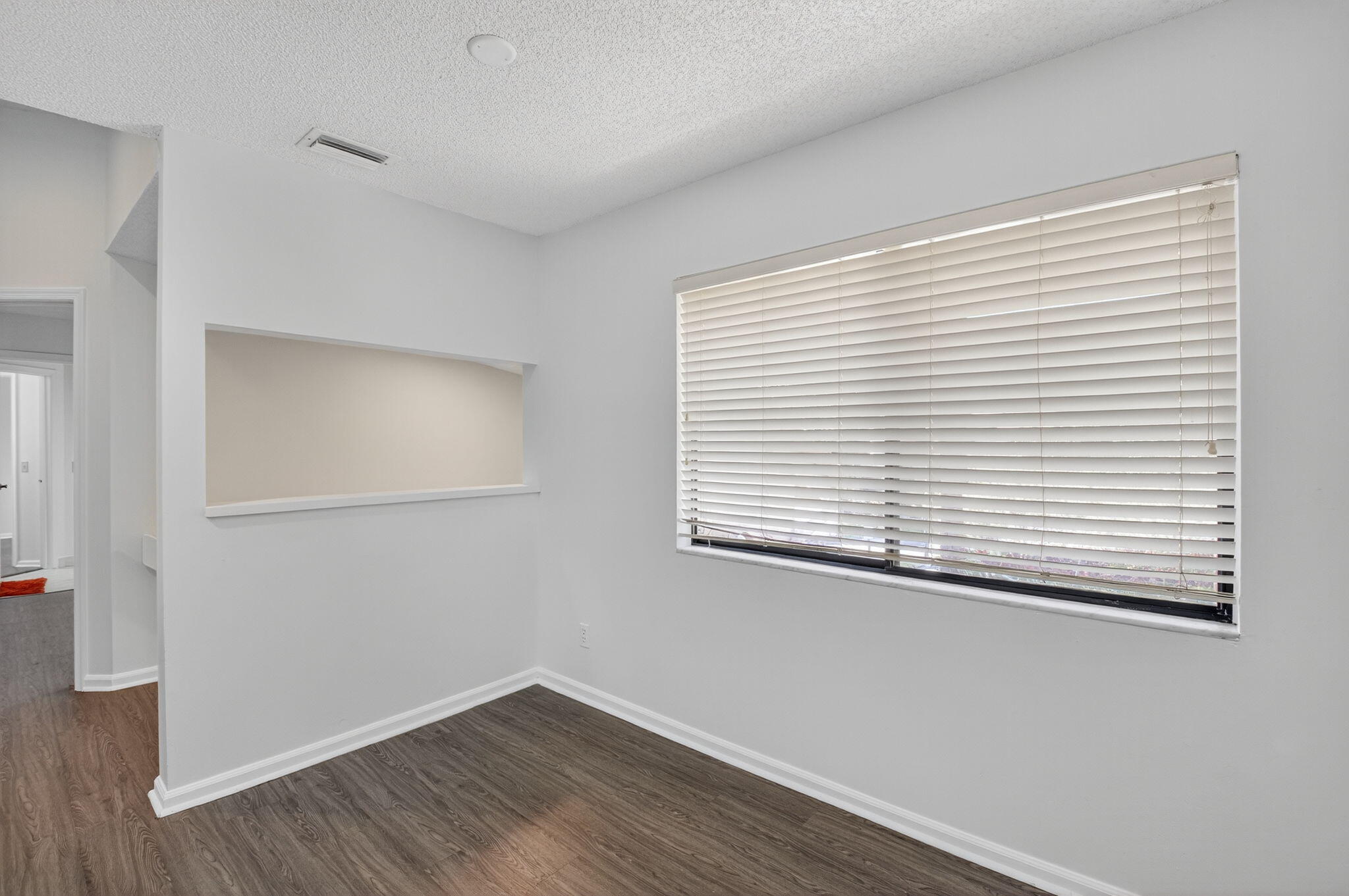 5530 Coach House Circle, Unit E Boca Raton, FL 33486 - Photo 13 of 40 a view of a small space with wooden floor and a window