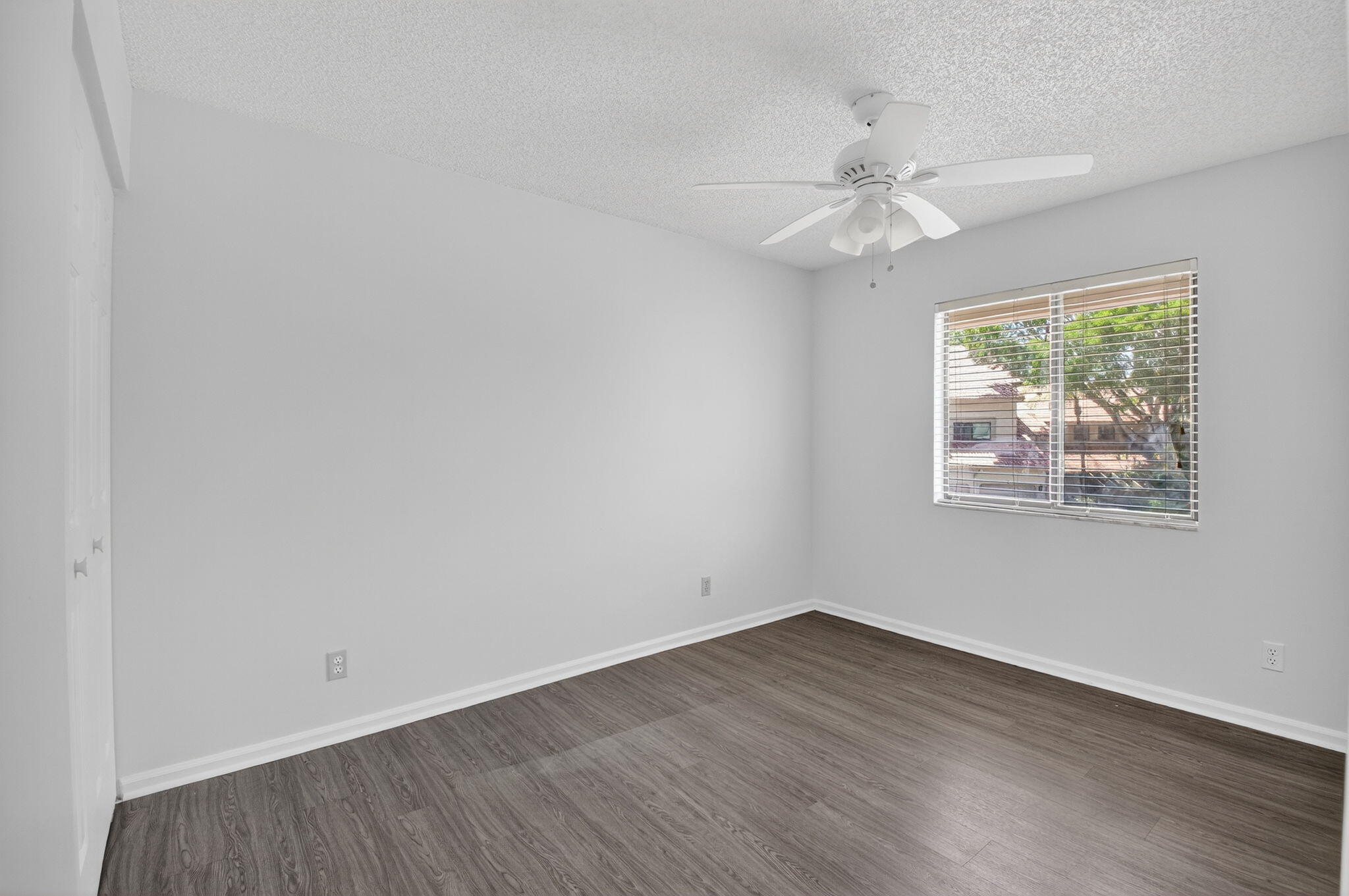 5530 Coach House Circle, Unit E Boca Raton, FL 33486 - Photo 23 of 40 wooden floor in an empty room with a window