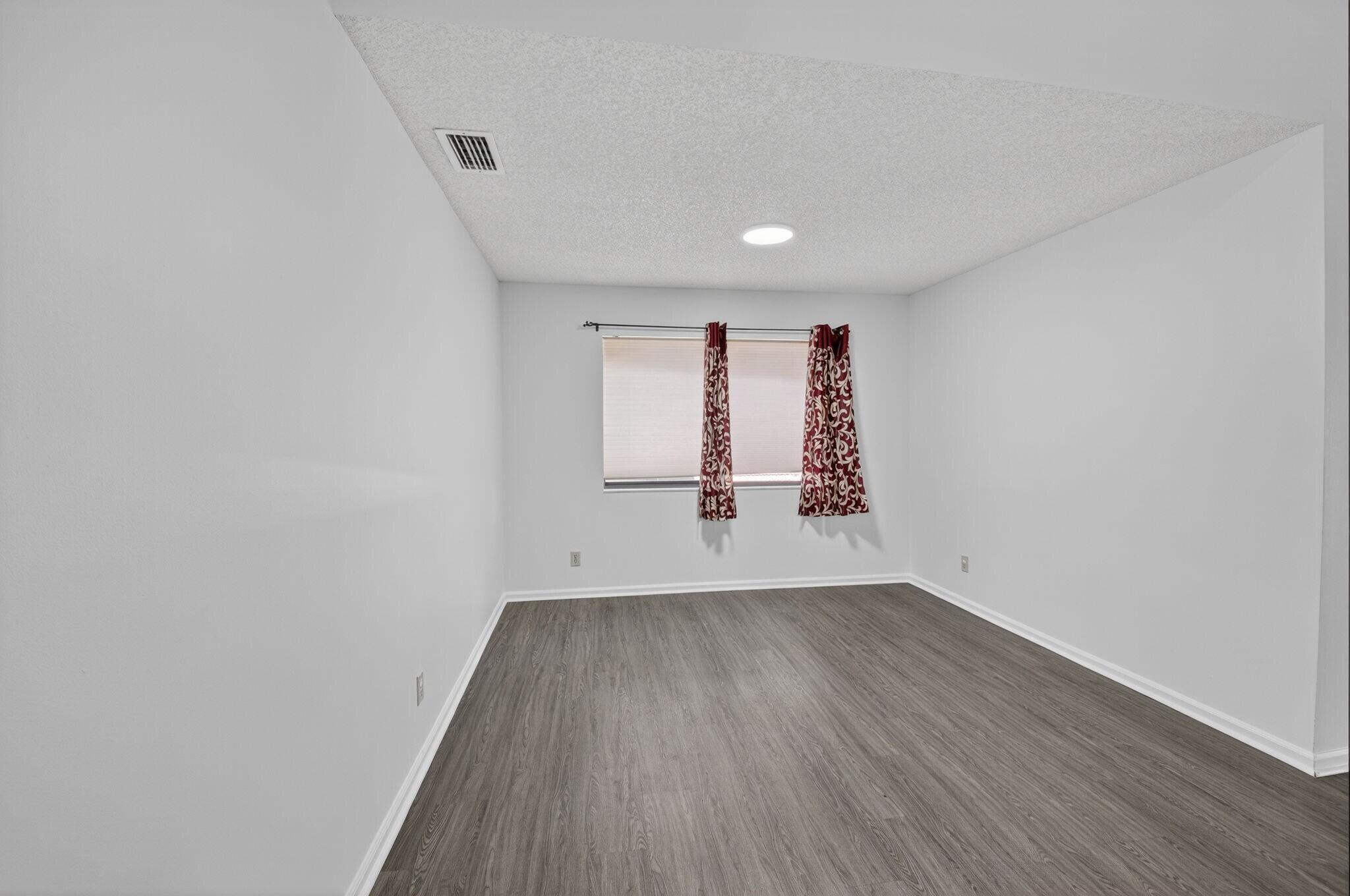 5530 Coach House Circle, Unit E Boca Raton, FL 33486 - Photo 8 of 40 wooden floor in an empty room with a window