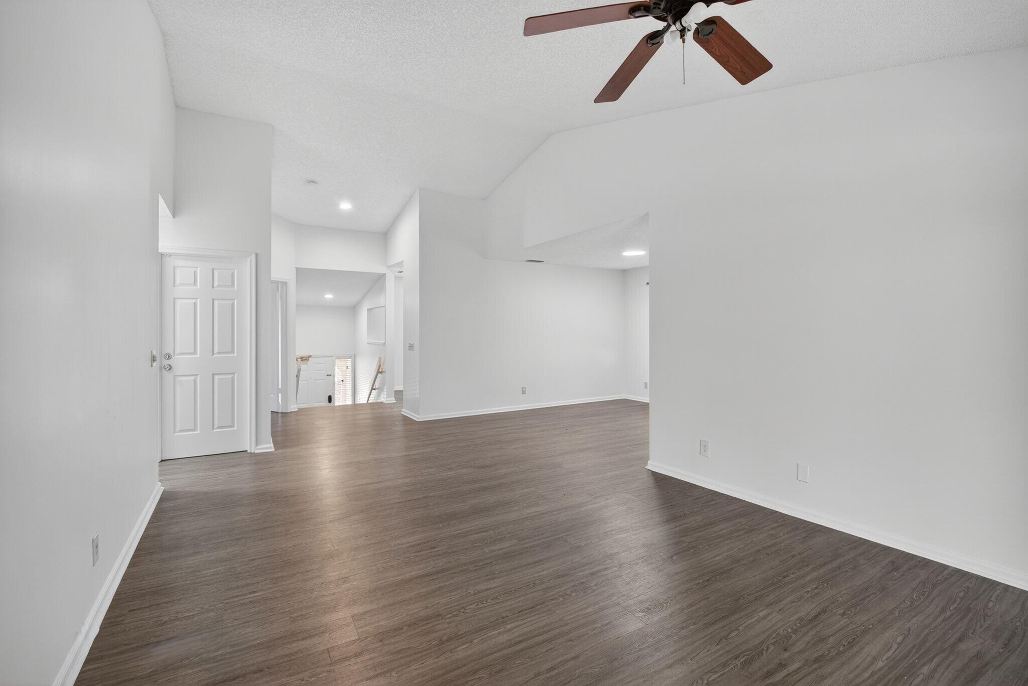 5530 Coach House Circle, Unit E Boca Raton, FL 33486 - Photo 9 of 40 a view of a room with wooden floor and white walls