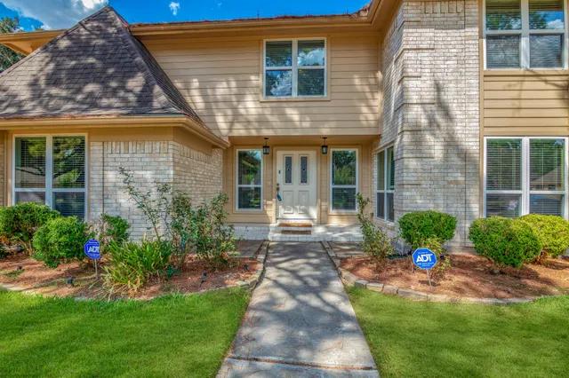 a front view of a house with a yard and outdoor seating