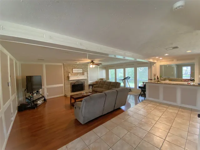 a living room with furniture window and a flat screen tv