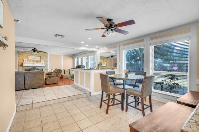 a view of a dining room and livingroom with furniture window and wooden floor