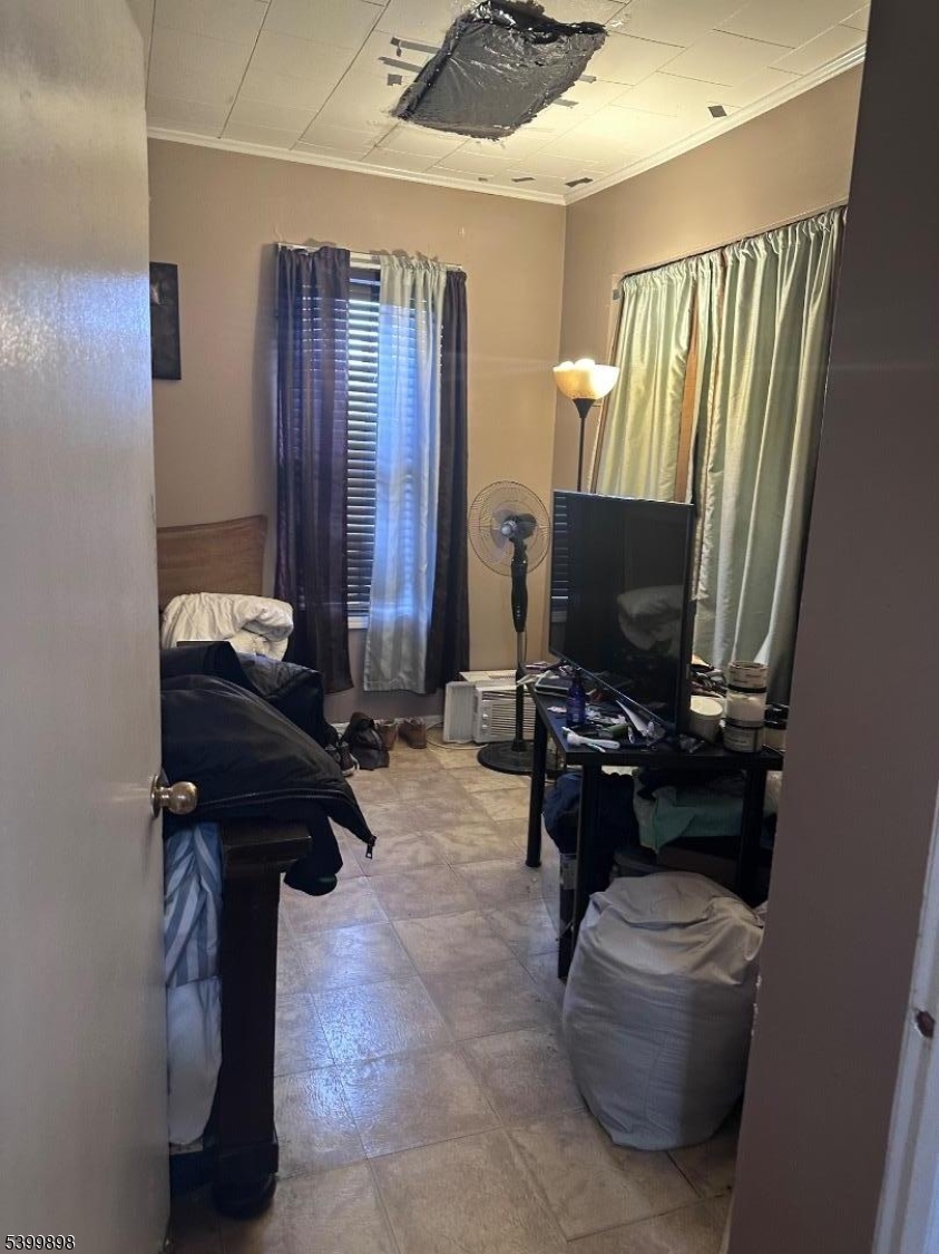 152 Jaques Street Elizabeth, NJ 07201 - Photo 10 of 23 a living room with furniture and a flat screen tv