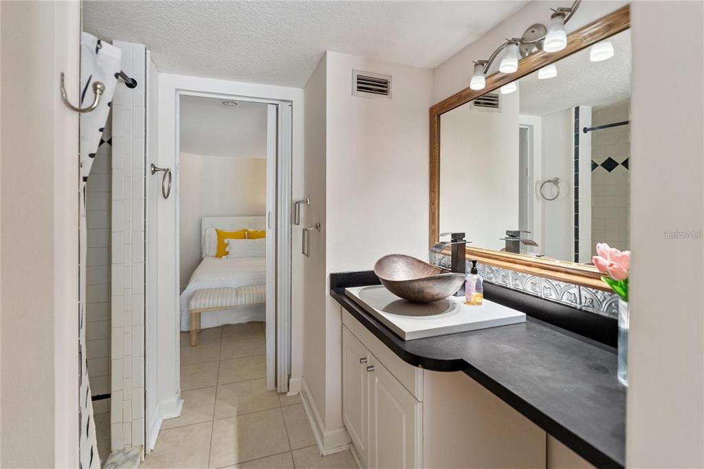 861 Nectar Road Venice, FL 34293 - Photo 53 of 74 a en suite bathroom with a granite countertop sink and a mirror