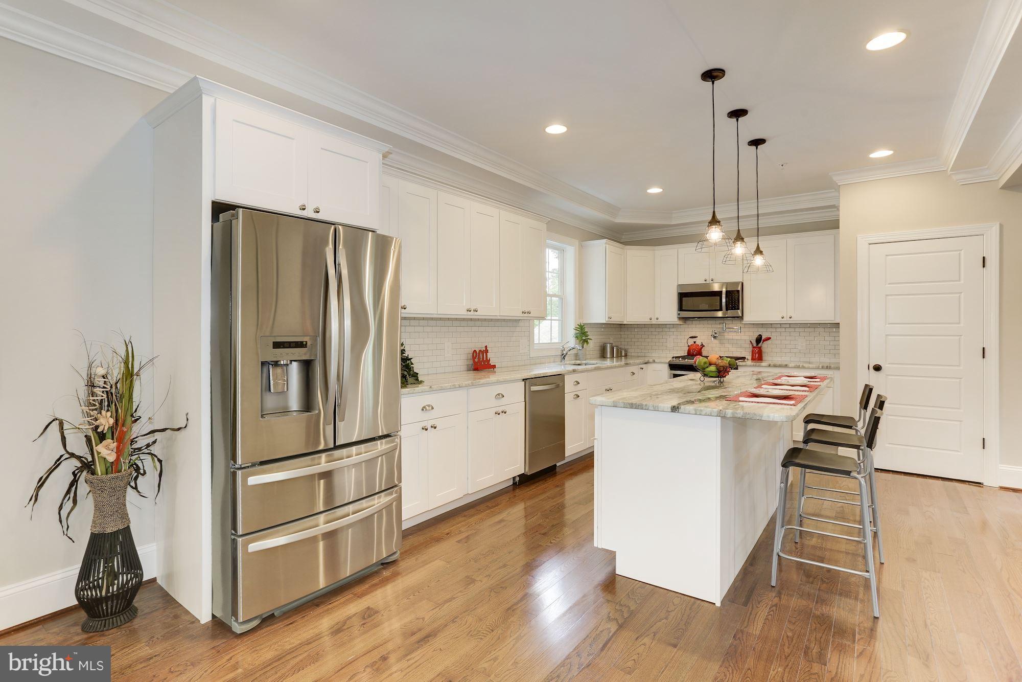 507 South Rolling Road Baltimore, MD 21228 - Photo 10 of 30 a kitchen with refrigerator cabinets and wooden floor